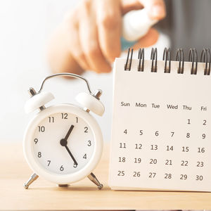 Alarm clock and desk calendar, cleaning routines and weekly cleaning schedule planner.