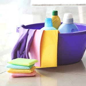 Cleaning bucket with sprays and microfiber cloths, products tools and supplies guide.