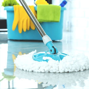 Mop and cleaning bucket on the floor, seasonal deep cleaning for kitchens and bathrooms.