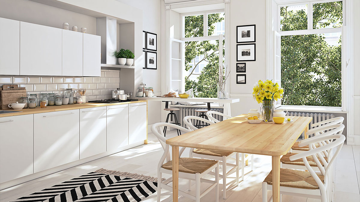 Sunlit, modern kitchen and dining area after cleaning, with clear counters and a tidy table ready for everyday use.